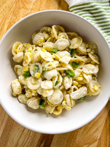 Jalapeño and corn pasta in a white bowl.