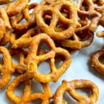 Honey mustard pretzel twits in a pile on a baking sheet.