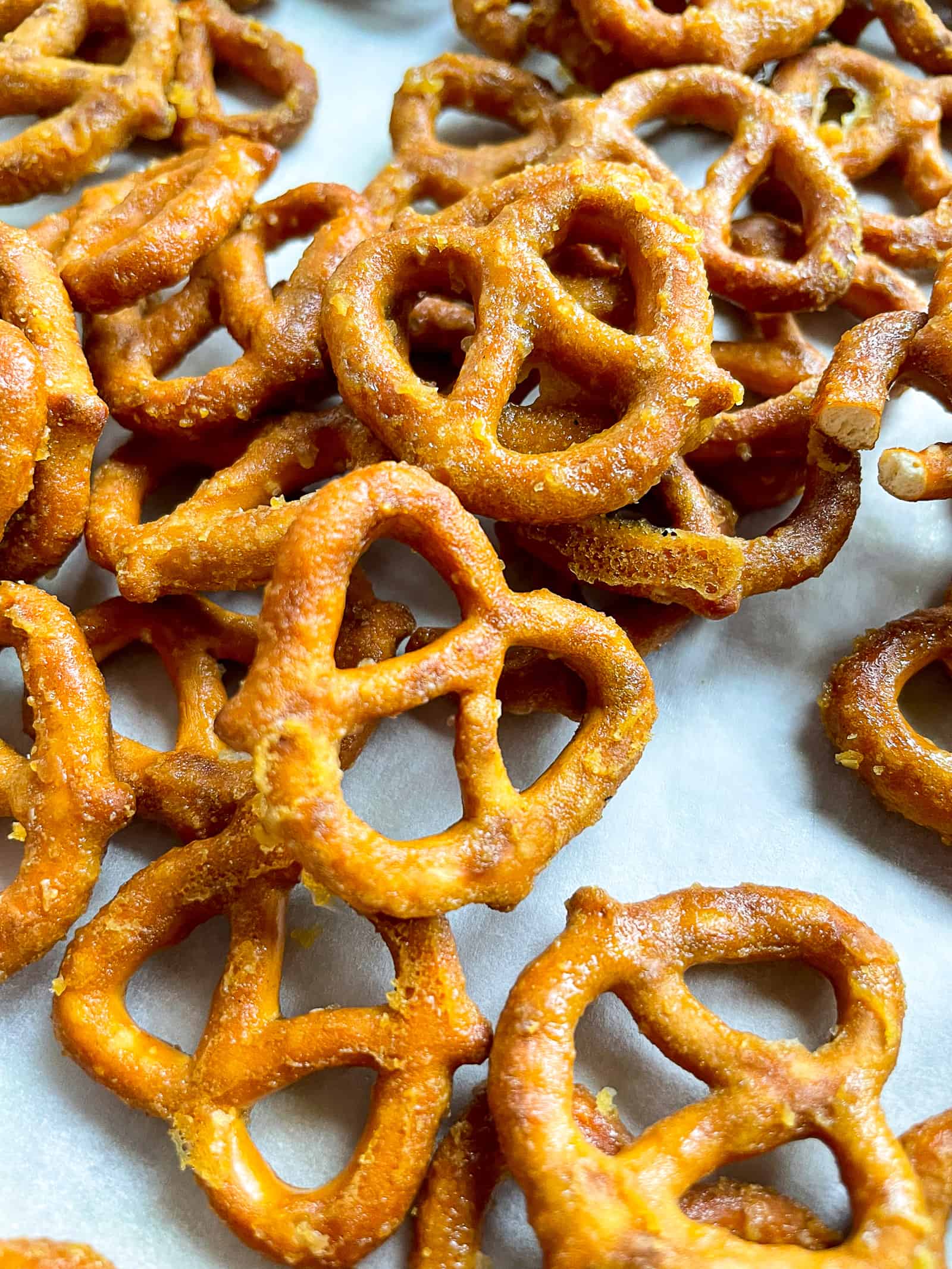 Honey mustard pretzel twits in a pile on a baking sheet.