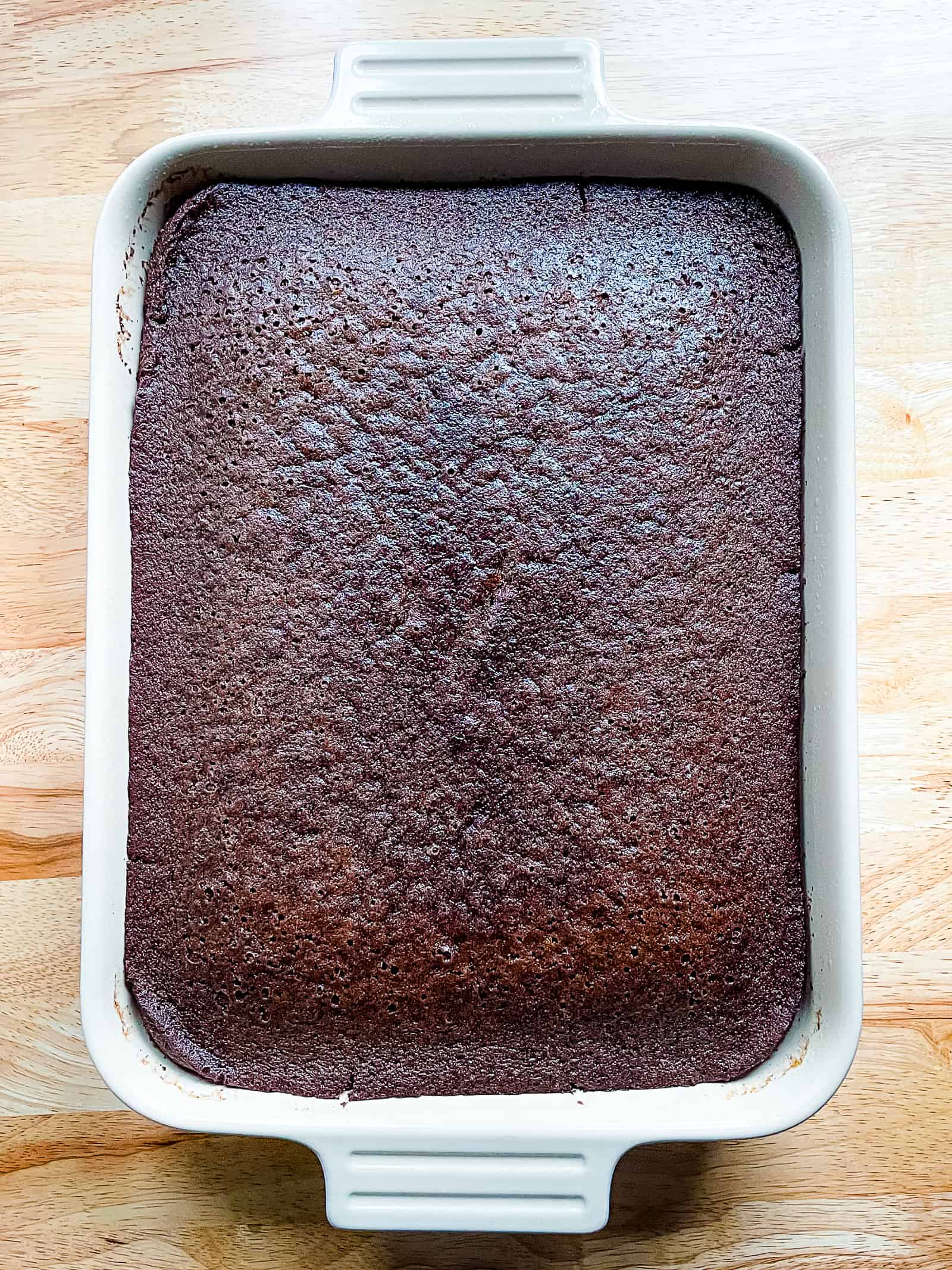 Chocolate crazy cake cooling in a pan. Cake is not frosted. 