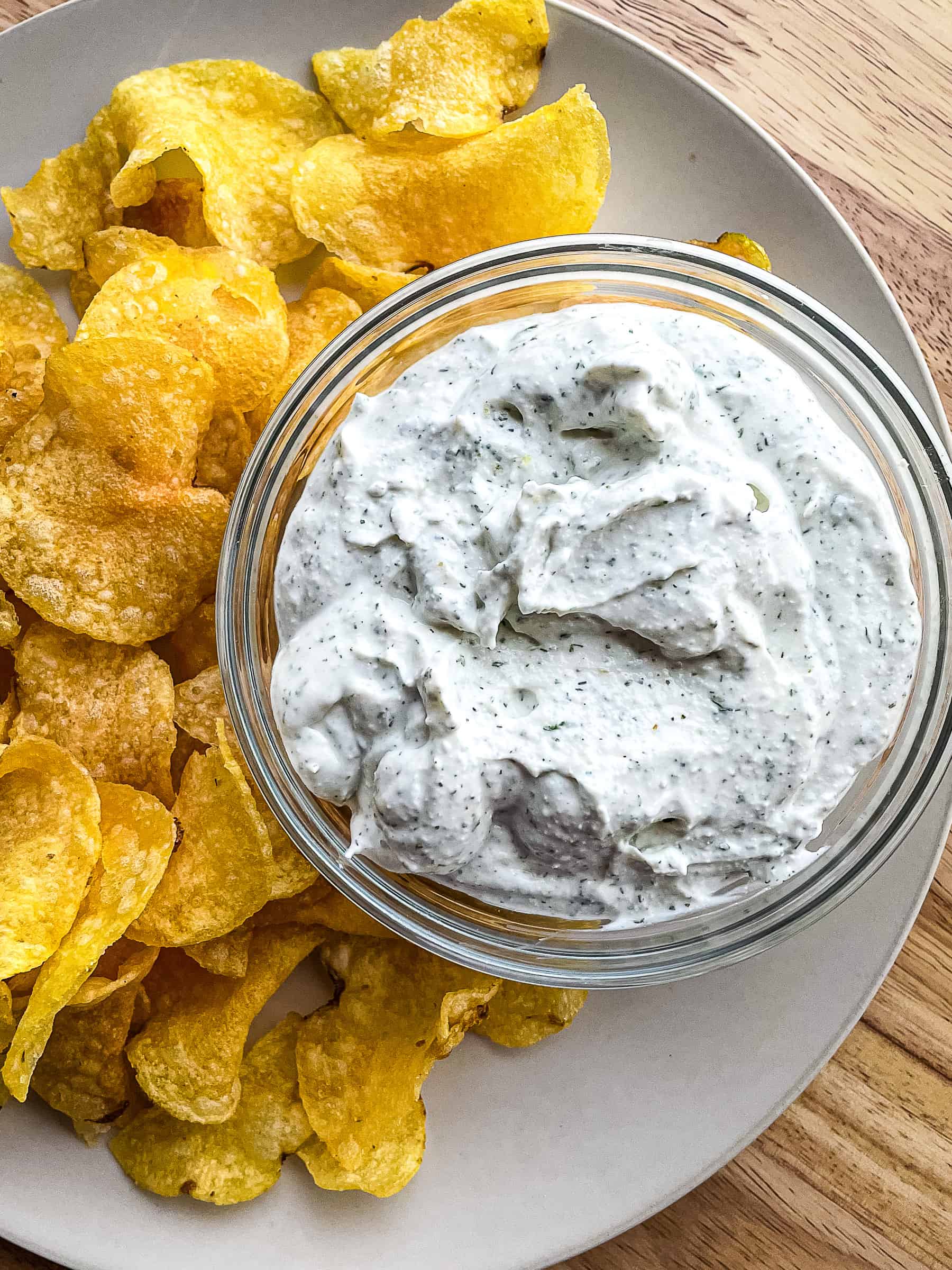 Cottage cheese dip and potato chips on a platter.