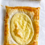 Puff pastry cream cheese danish cooling on a baking sheet.