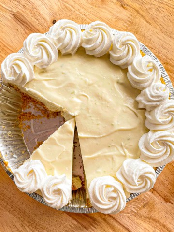 No-bake lime pie topped with a border of whipped cream rosettes.