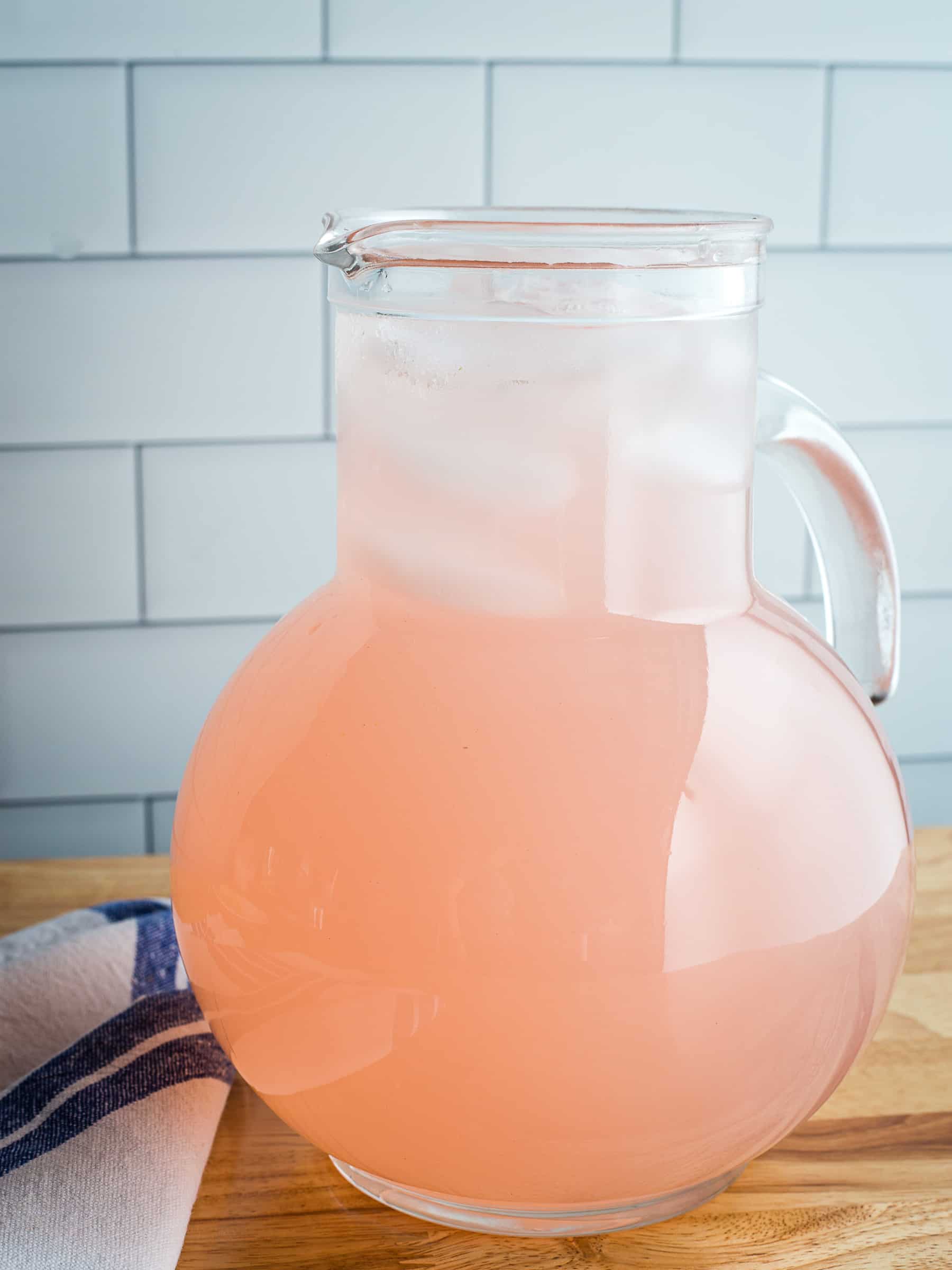 Pink lemonade in a glass pitcher.