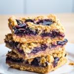 Three blueberry crumb bars in a stack.