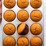 Baked pumpkin muffins in a pan.