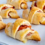 Ham and cheese crescent roll on a baking sheet.