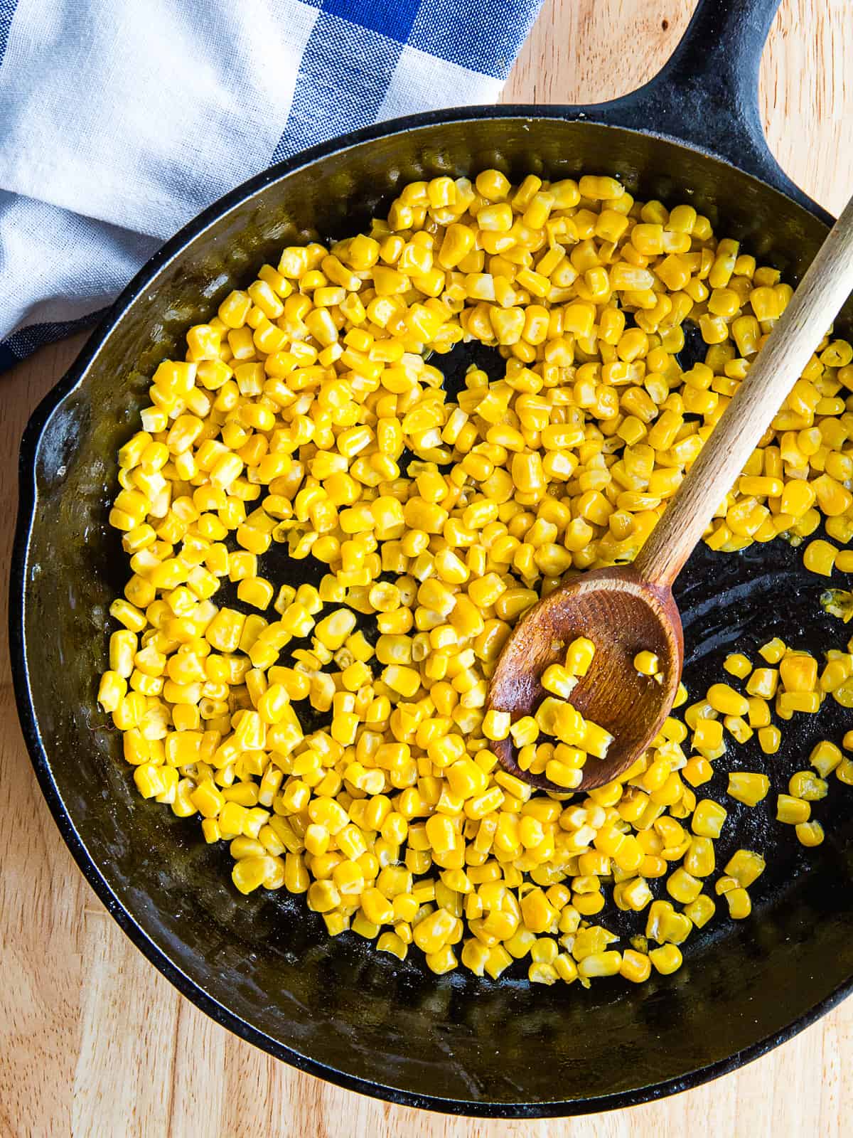 Frozen corn cooked in a skillet.