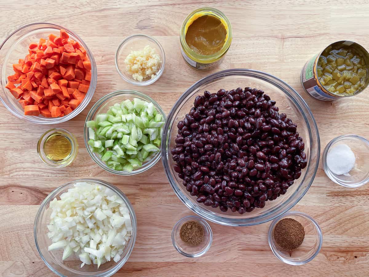 Ingredients for black bean soup on the counter in individual bowls. 