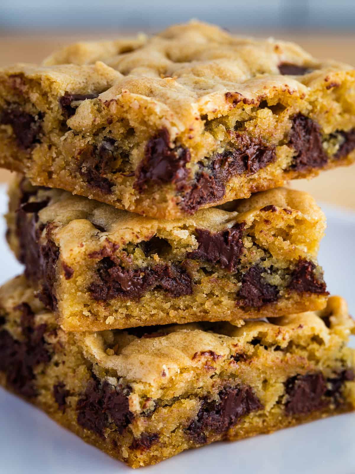 Three chocolate chip cookie bars in a stack.