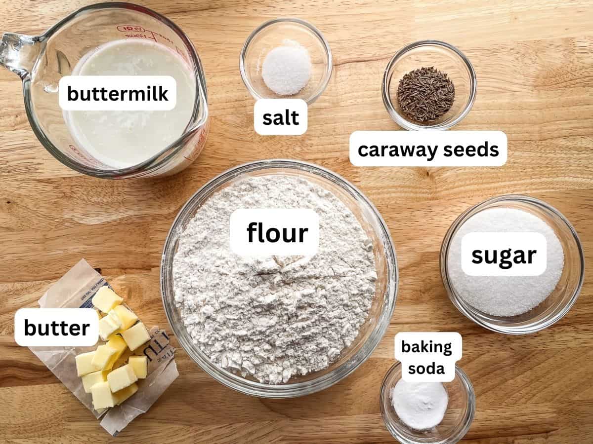The ingredients for caraway Irish soda bread on a counter in individual bowls.