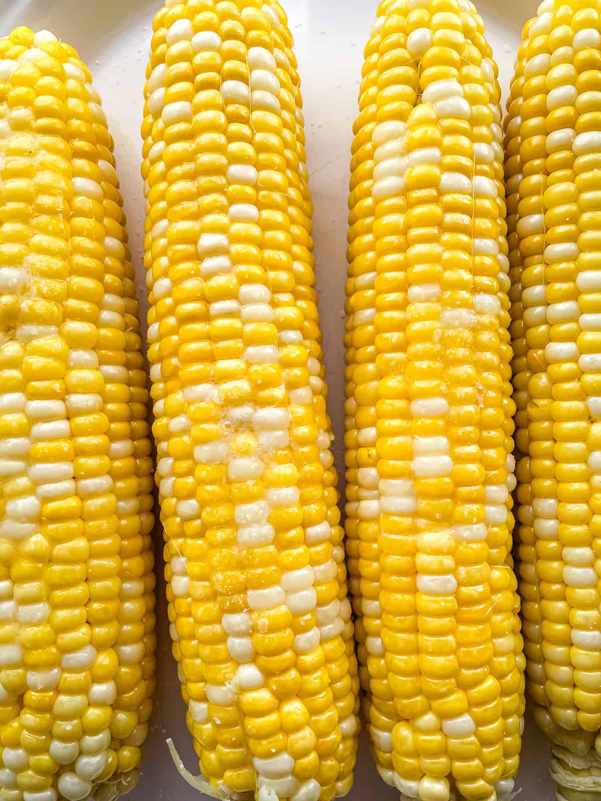 Boiled corn spread with butter and sprinkled with salt.