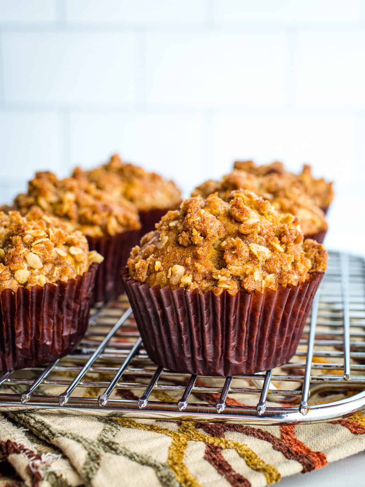Zucchini crumb muffins cooling on a rack.