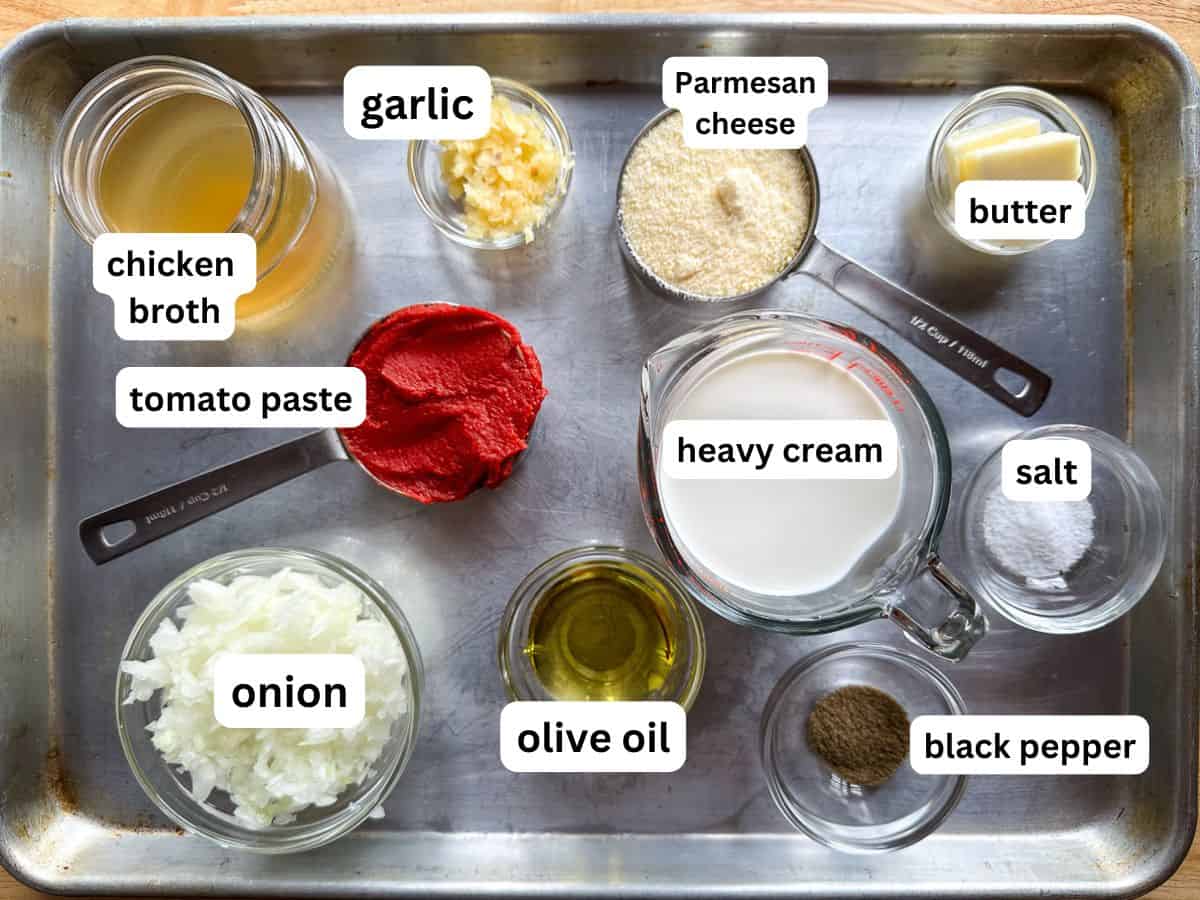 Ingredients for tomato cream sauce. Measured and placed on a baking sheet.