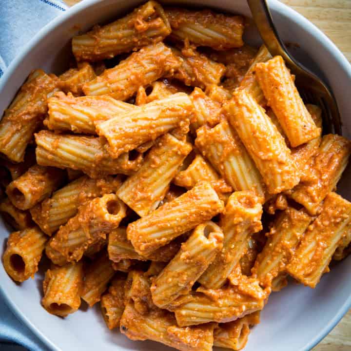 A bowl of pasta with tomato cream sauce.
