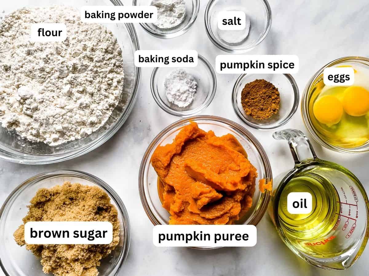 Ingredients for pumpkin muffins measured and placed in bowls on the counter.