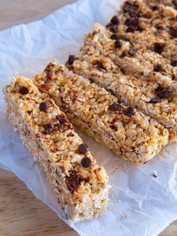 Homemade chewy granola bars topped with chocolate chips.