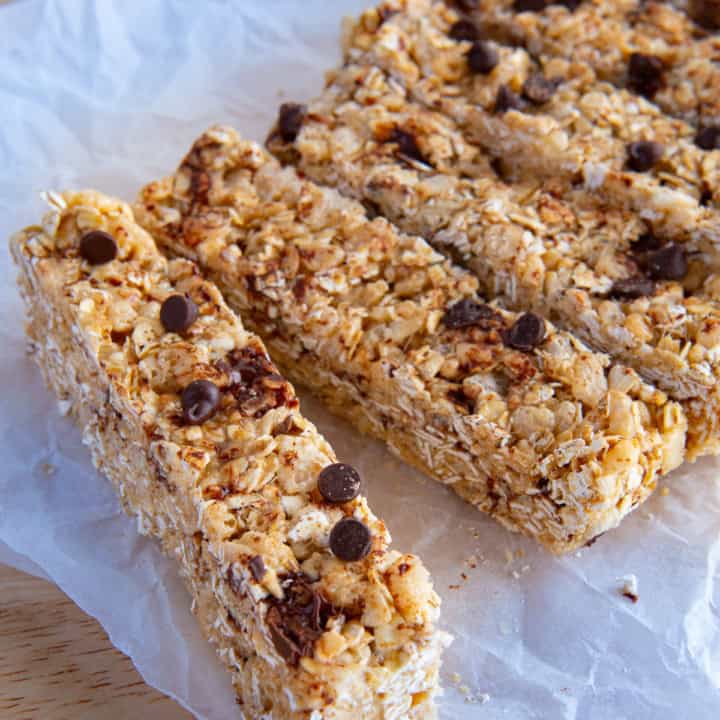 Homemade chewy granola bars topped with chocolate chips.