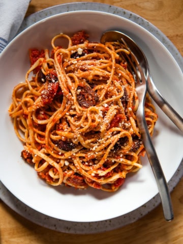 Pasta puttanesca on a plate.