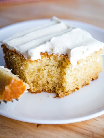 Slice of eggless vanilla cake on plate.